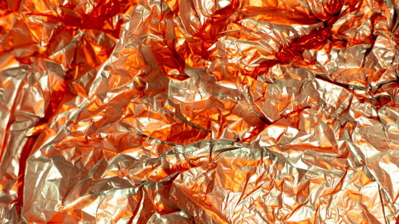 brown dried leaves on red textile