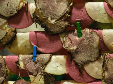 Sliced meats and cheese are dried with clothespins.