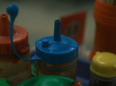 A close up of a baby bottle with a baby bottle next to it